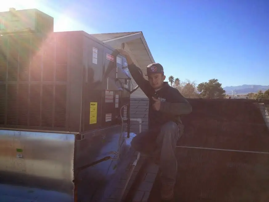 HVAC technician performing Air Duct Cleaning on a rooftop unit in Mill Creek